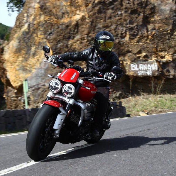 A red 2020 Triumph Rocket 3 being ridden on a road